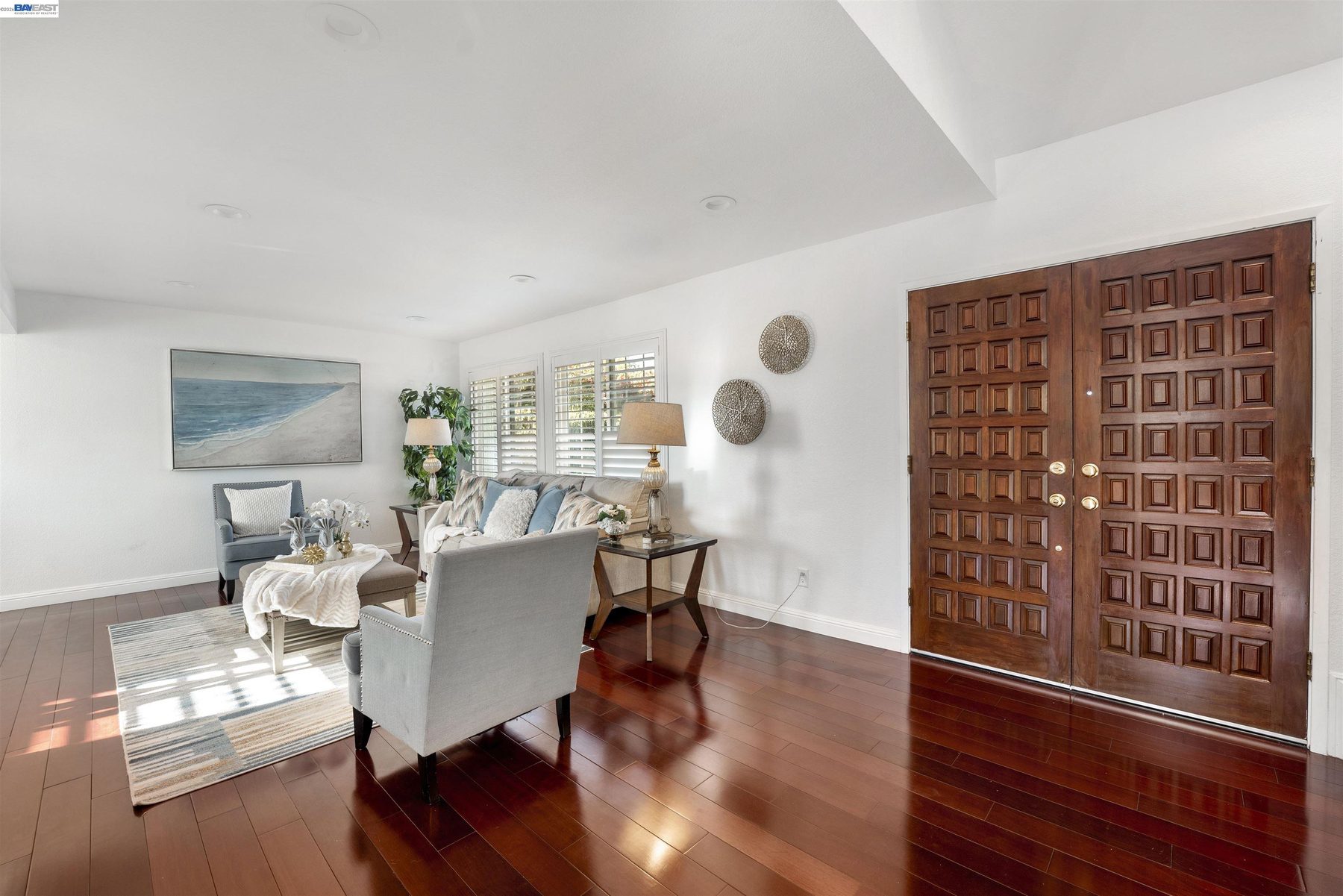 Foyer with hardwood floors and carved double entry doors