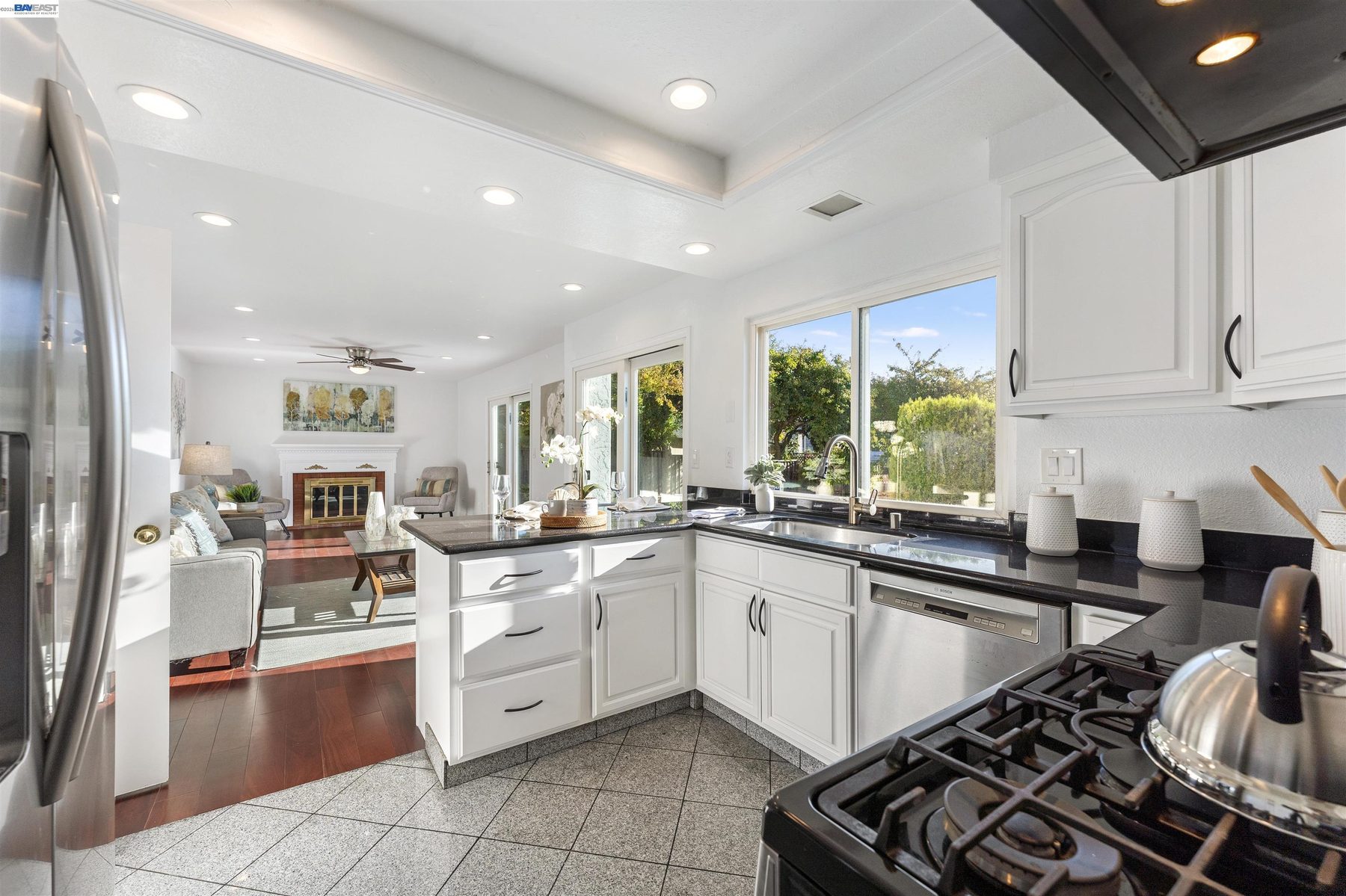 Kitchen with gas cooktop and garden window views