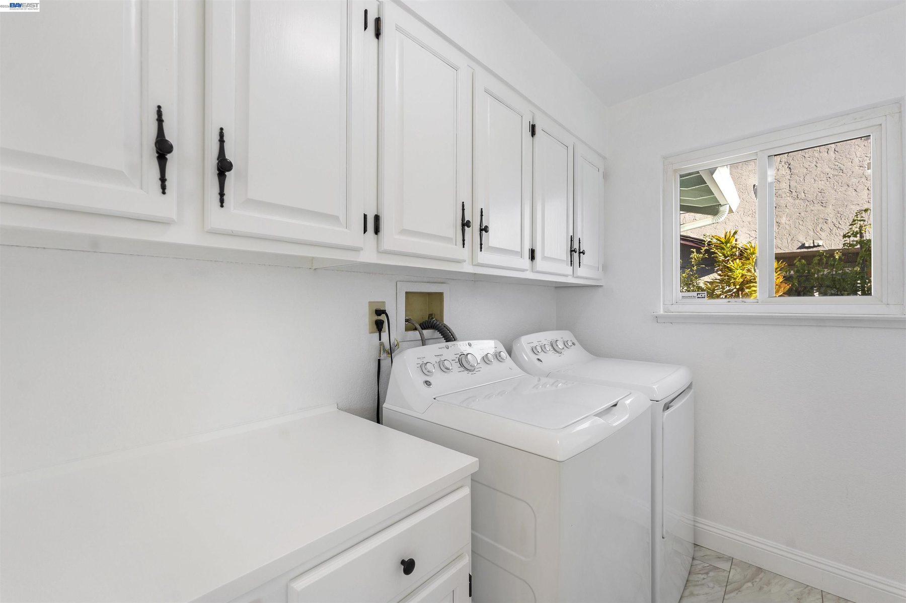 Interior laundry room with cabinetry